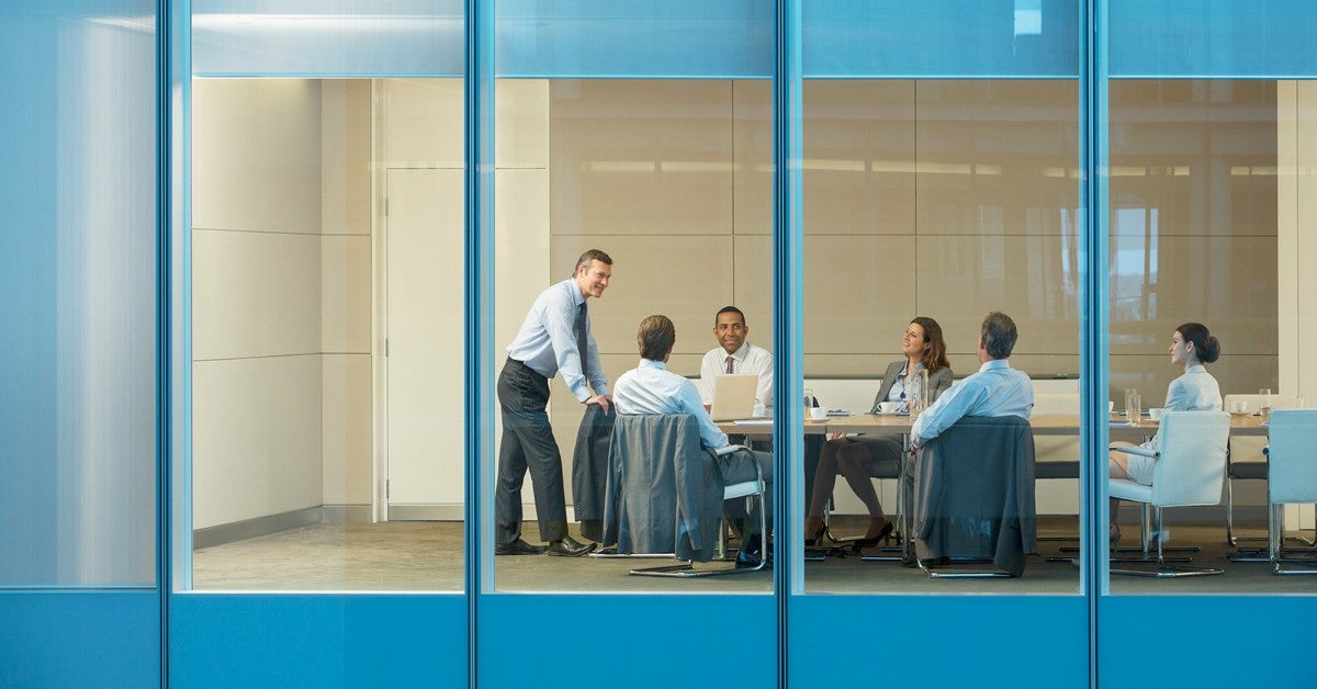 business meeting at a desk in a conference room