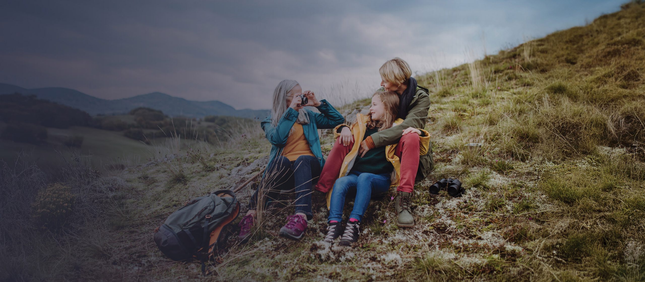 A cheerful family enjoys an outdoor hiking adventure, with parents and children embracing nature and shared moments of fun.