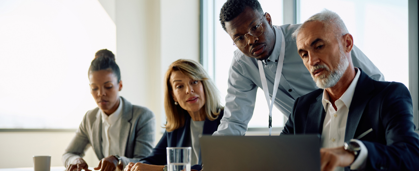 A professional team of businesspeople collaborates during a meeting in a modern office setting, fostering productive discussions.