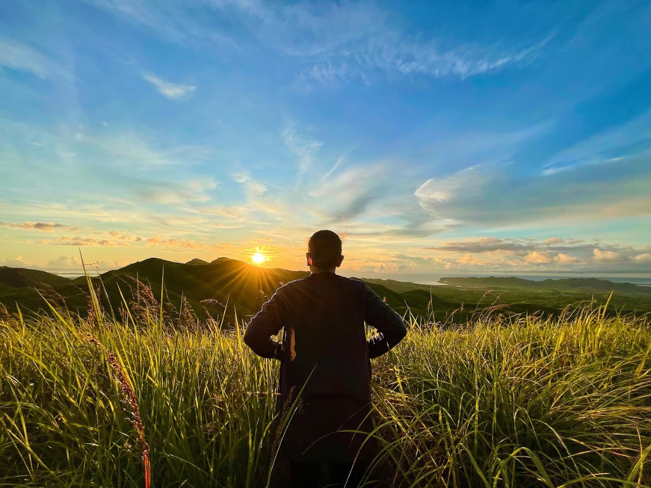 Woman looking at mountain sunrise