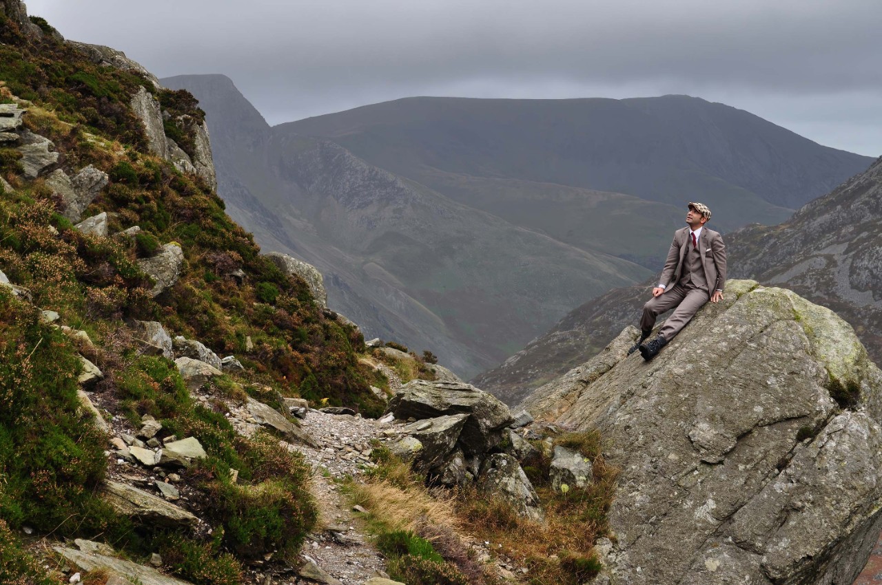 Man on mountain in suit