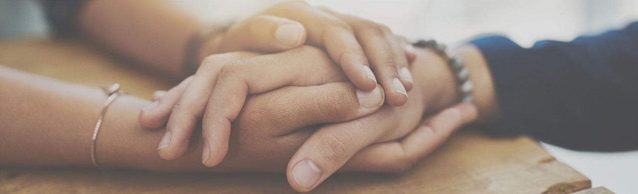 Closeup shot of two unrecognizable people holding hands in comfort