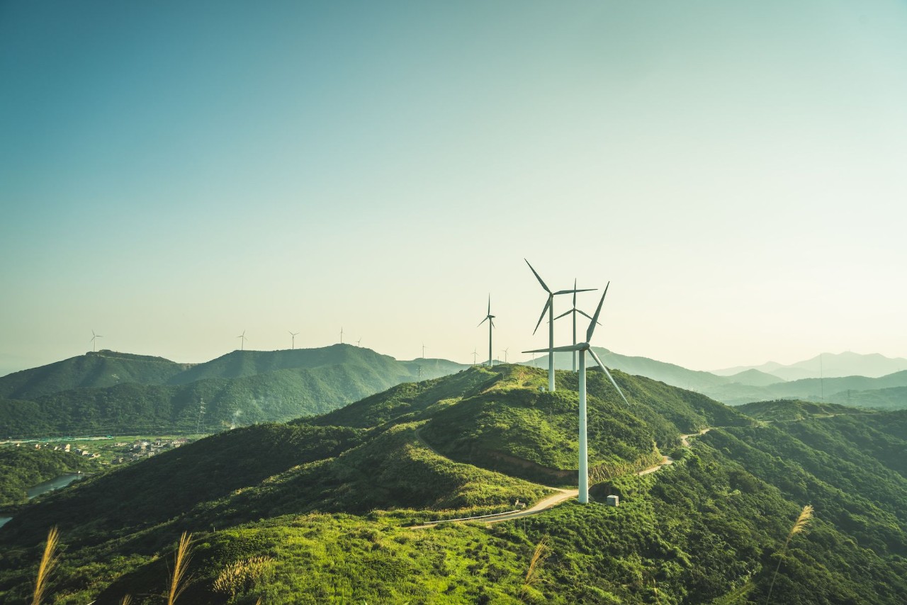 windmills on top of a green hill