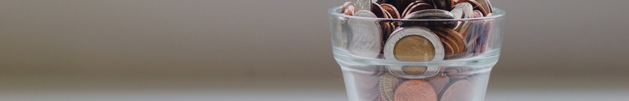 coins in a transparent glass