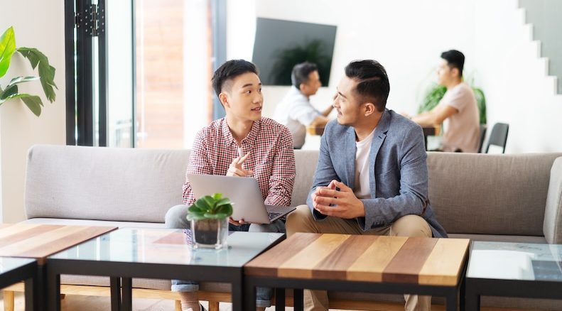 Two men sitting on couch